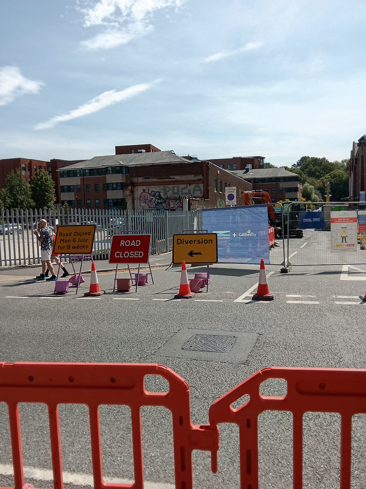 Road closed and diversion signage at a city centre works site